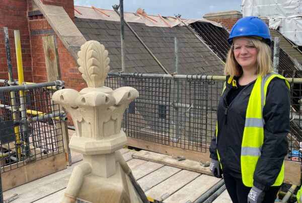 Victoria Parcroft next to new finial replacing one that had been missing for decades