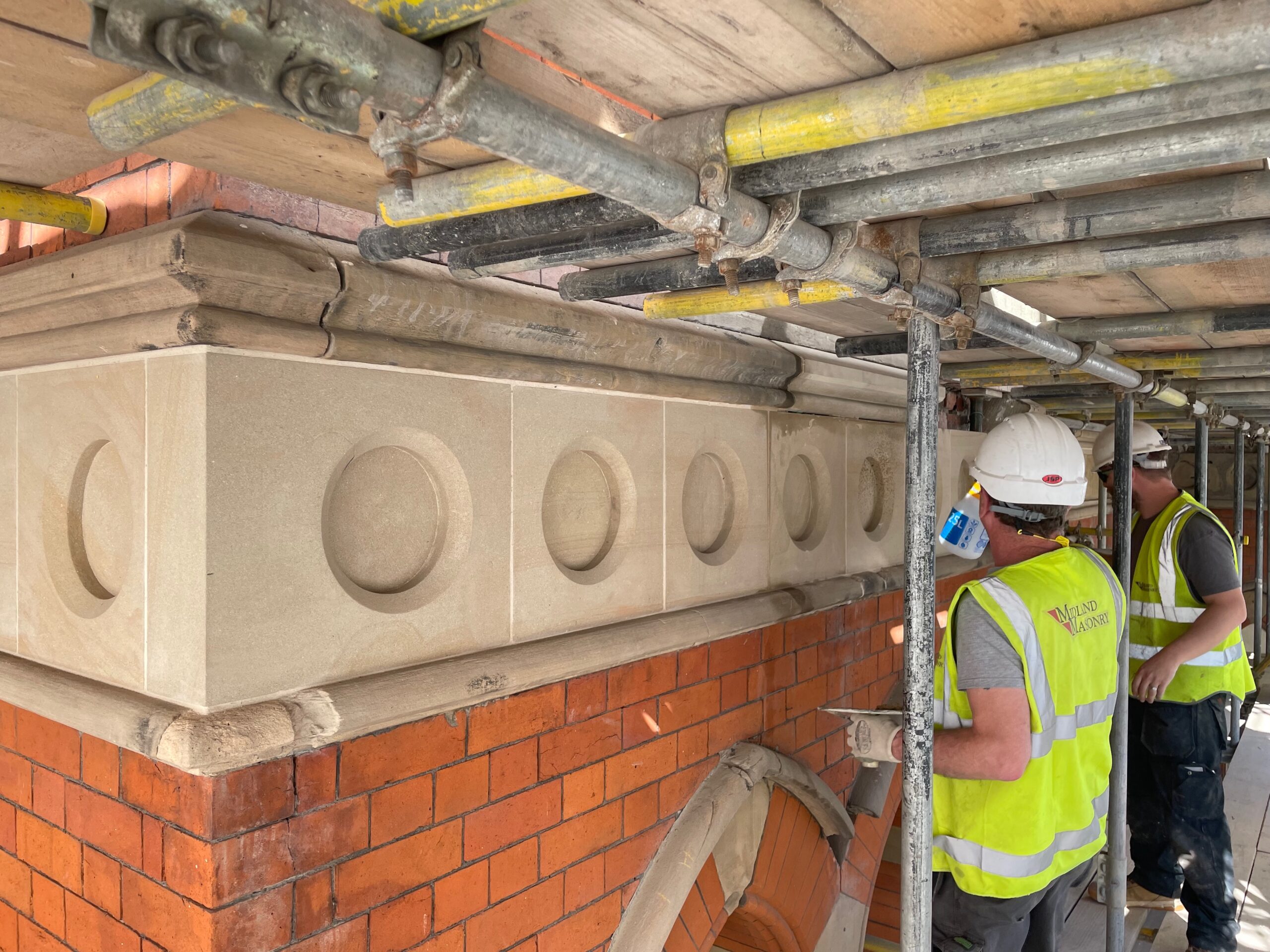 Stonemasons installing replacement stonework